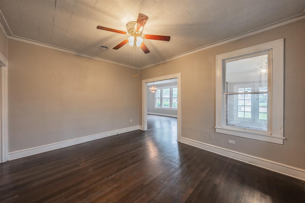 1500 Proctor Avenue Waco, TX 76708 - Photo 15 of 40 The property features dark hardwood flooring, neutral-toned walls, and a ceiling fan with integrated lighting