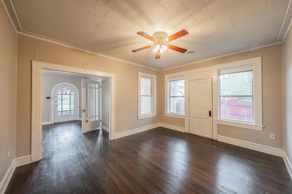 1500 Proctor Avenue Waco, TX 76708 - Photo 16 of 40 This room features dark wood flooring, light-colored walls, and a ceiling fan with wooden blades