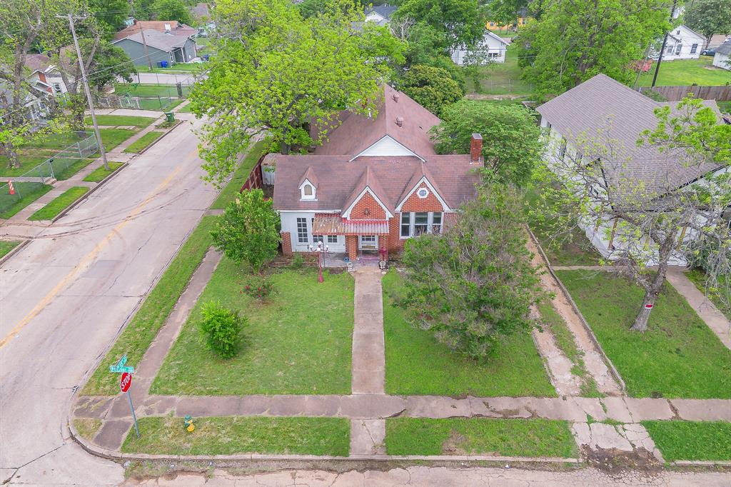 1500 Proctor Avenue Waco, TX 76708 - Photo 3 of 40 The property features a traditional architectural style with a prominent gabled roof and a brick chimney