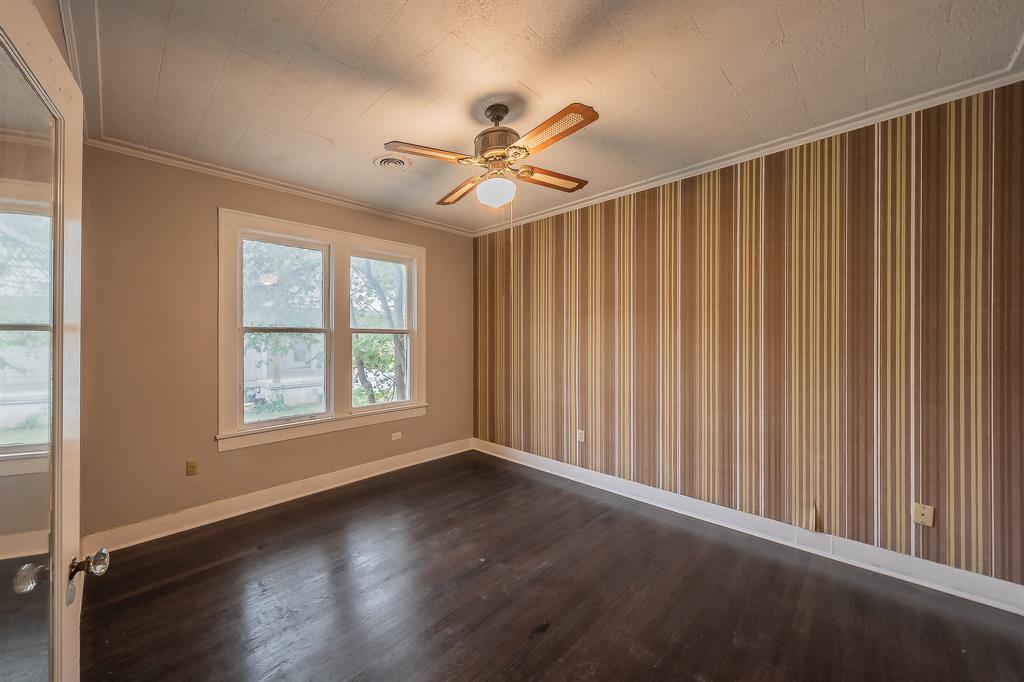1500 Proctor Avenue Waco, TX 76708 - Photo 37 of 40 This room features dark hardwood flooring, a ceiling fan with light fixture, and two windows providing natural light