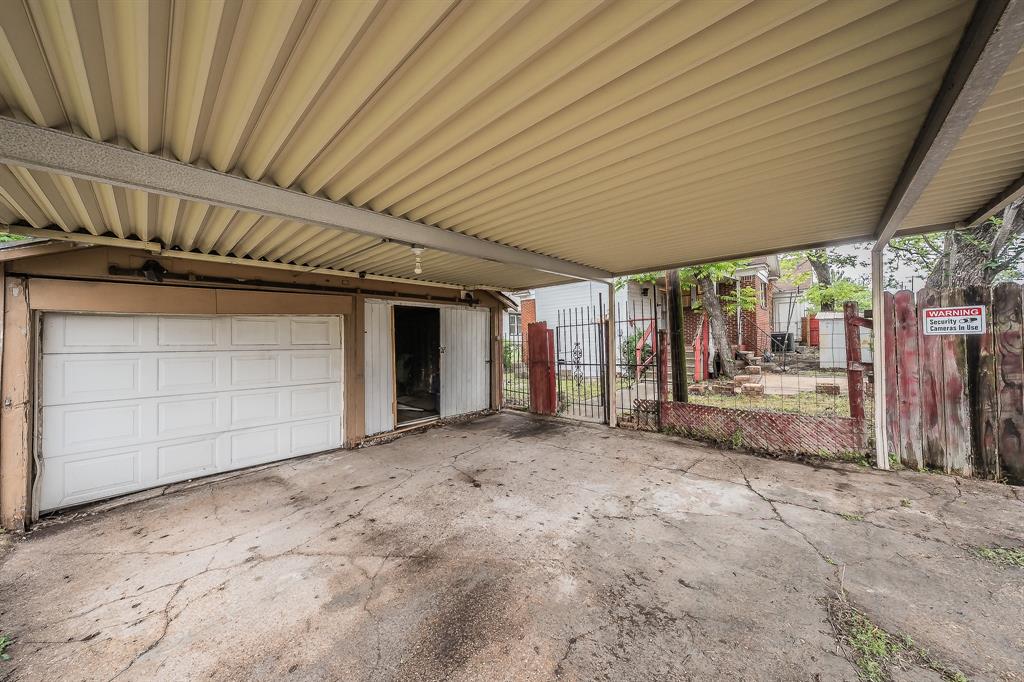 1500 Proctor Avenue Waco, TX 76708 - Photo 38 of 40 Covered parking area with concrete flooring, a single garage door, and a partially open doorway