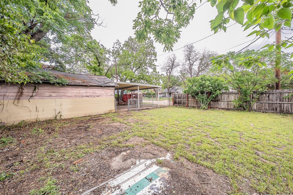1500 Proctor Avenue Waco, TX 76708 - Photo 40 of 40 The property features a spacious yard with a wooden fence and mature trees