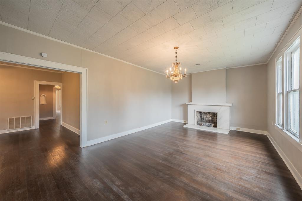 1500 Proctor Avenue Waco, TX 76708 - Photo 6 of 40 Living area featuring dark hardwood floors, a white mantelpiece, and a chandelier