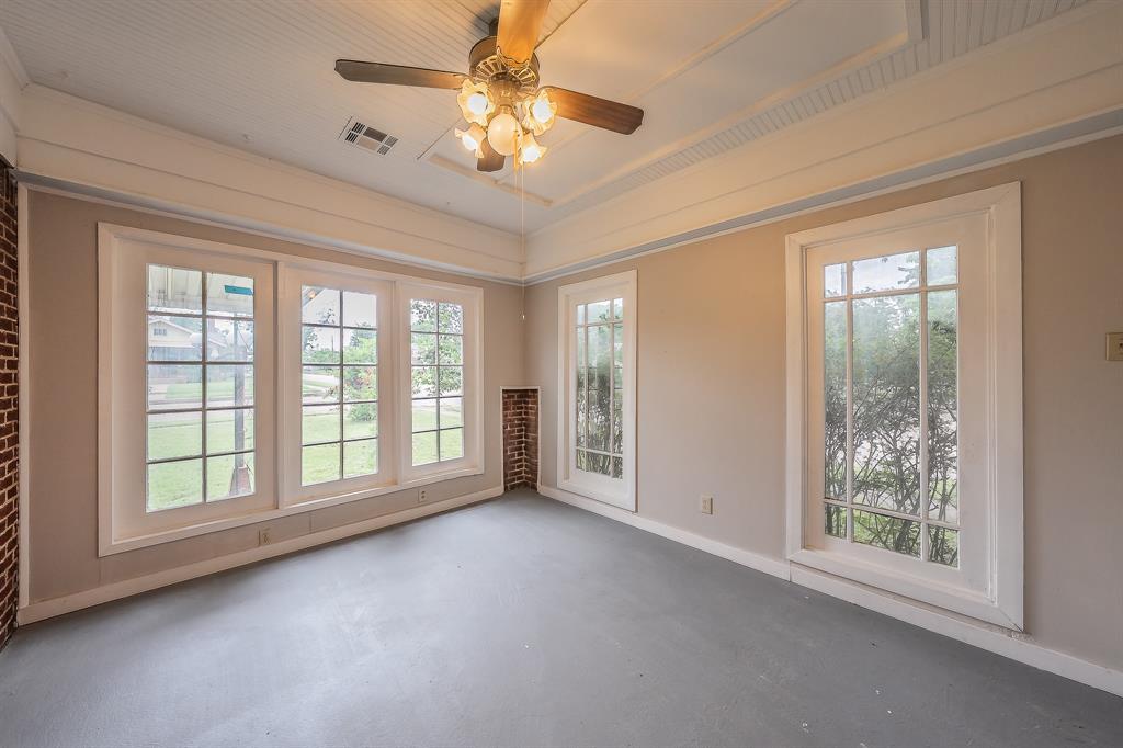 1500 Proctor Avenue Waco, TX 76708 - Photo 10 of 40 The interior features exposed brick accents, large windows, and a classic ceiling fan with integrated lighting