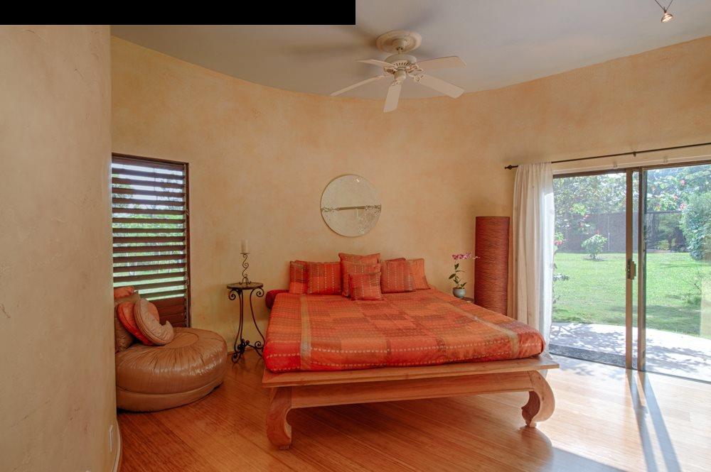 107 West Kuiaha Road Haiku, HI 96708 - Photo 14 of 20 a bedroom with a bed and ceiling fan