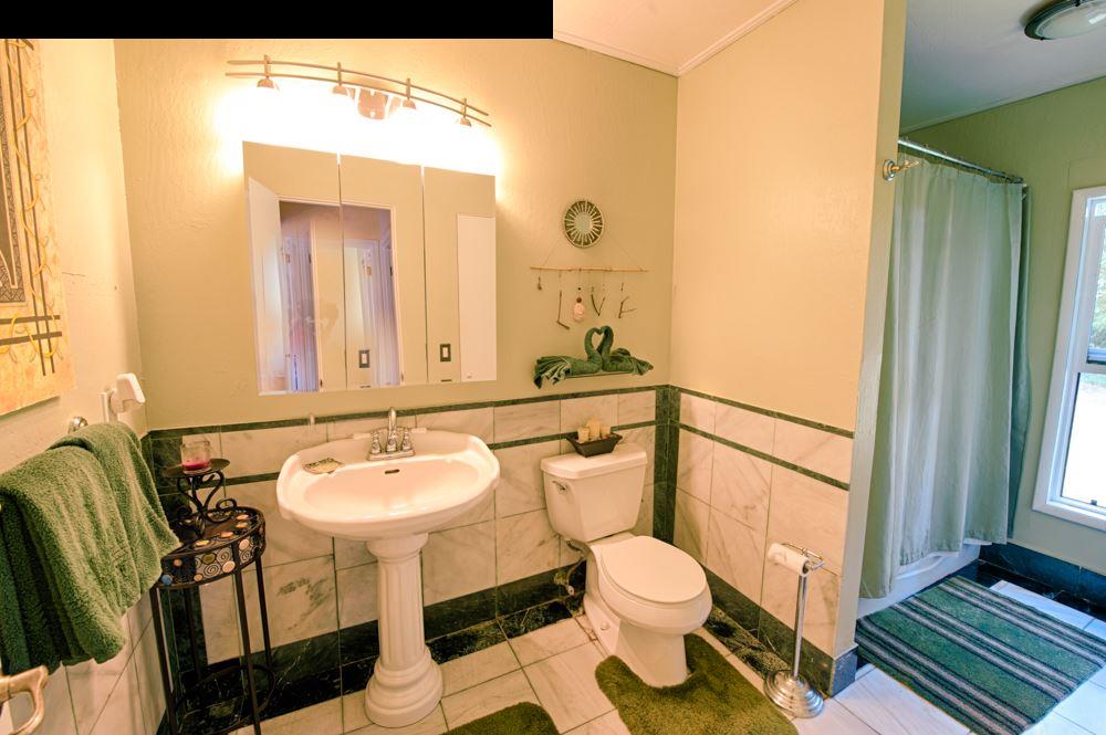 107 West Kuiaha Road Haiku, HI 96708 - Photo 16 of 20 a bathroom with a sink toilet and mirror