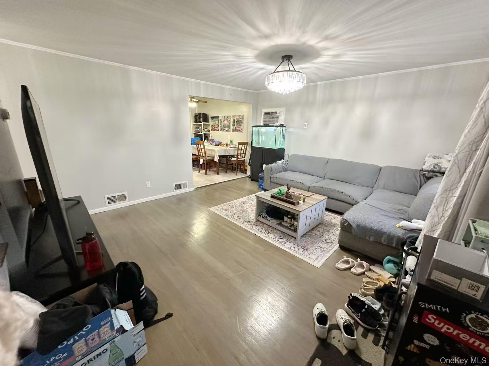 69 Virginia Avenue Plainview, NY 11803 - Photo 3 of 9 a living room with furniture and a flat screen tv