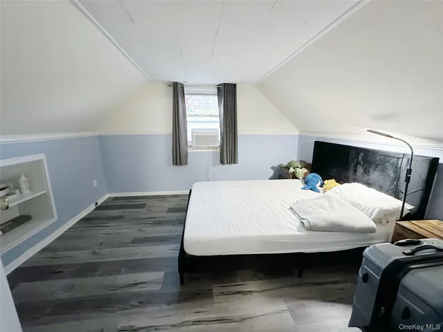 a bed sitting in a bedroom next to a window