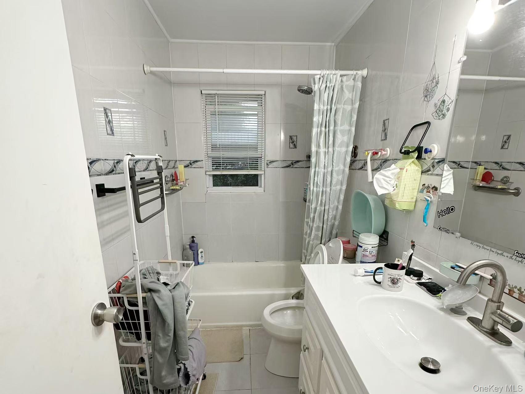 69 Virginia Avenue Plainview, NY 11803 - Photo 8 of 9 a bathroom with a sink a toilet and shower