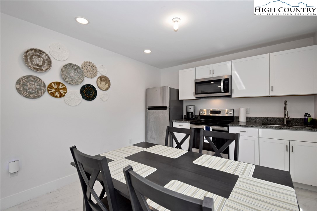 269 Willow Mountain Drive Vilas, NC 28692 - Photo 22 of 37 a kitchen with a table chairs and a refrigerator