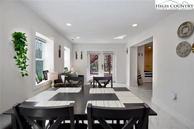 a living room with furniture and a book shelf