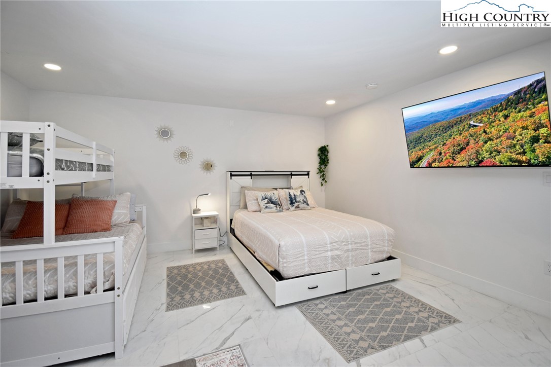 269 Willow Mountain Drive Vilas, NC 28692 - Photo 26 of 37 a bedroom with a bed and painting on the wall