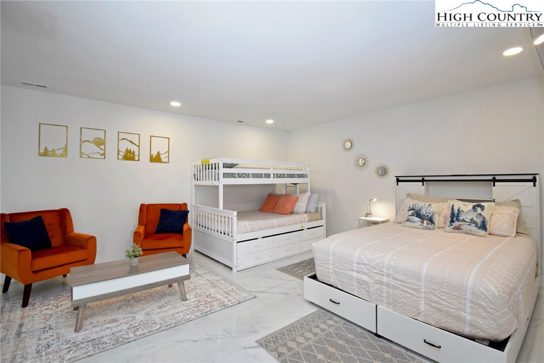 269 Willow Mountain Drive Vilas, NC 28692 - Photo 28 of 37 a bedroom with two beds and a couch