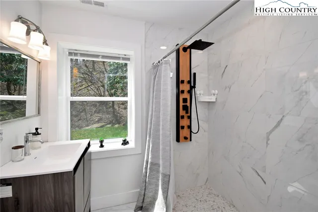 a bathroom with a sink a toilet and a window