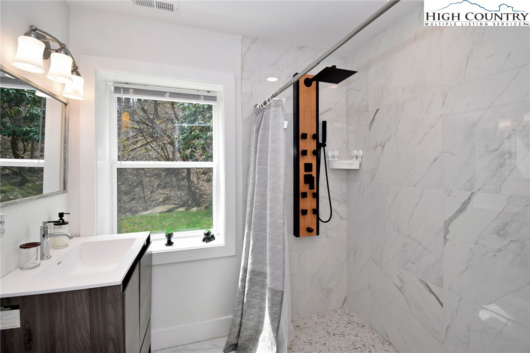 269 Willow Mountain Drive Vilas, NC 28692 - Photo 32 of 37 a bathroom with a sink vanity granite and a shower