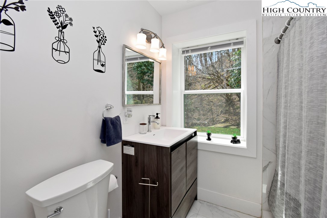 269 Willow Mountain Drive Vilas, NC 28692 - Photo 34 of 37 a bathroom with a sink a toilet and a window