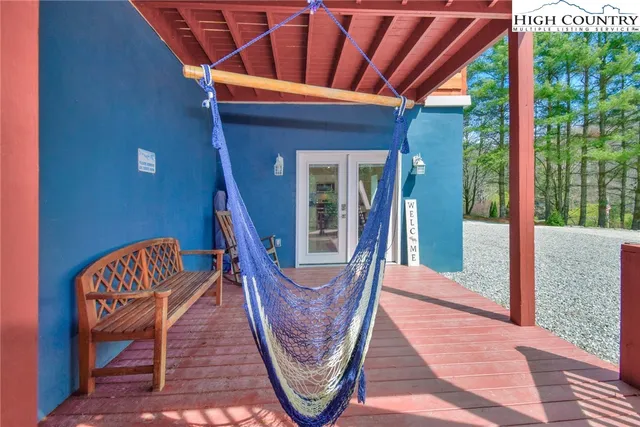 a living room with furniture and large windows