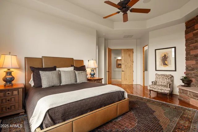 a bedroom with a bed window and a flat screen tv