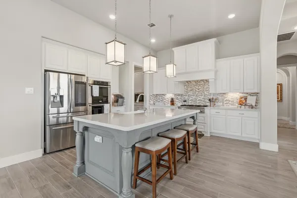 a living room with furniture fireplace and large windows