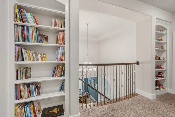 a living room with furniture and a ceiling fan
