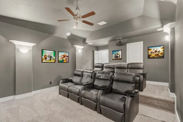 a bedroom with a bed a chandelier and a window
