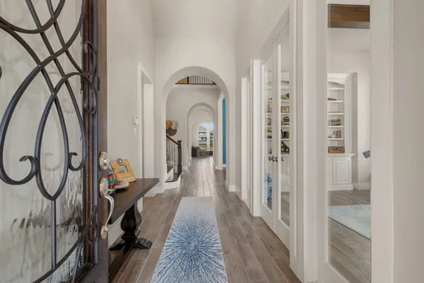 a view of entryway and hall with wooden floor