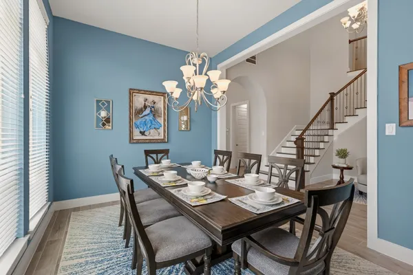 a view of kitchen with center island stainless steel appliances cabinets and wooden floor