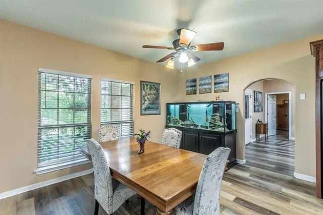 a living room with furniture flat screen tv and large window