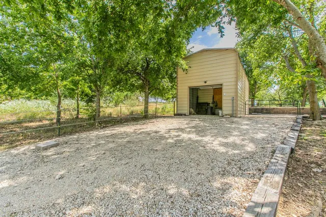 a view of a house with pool and trees