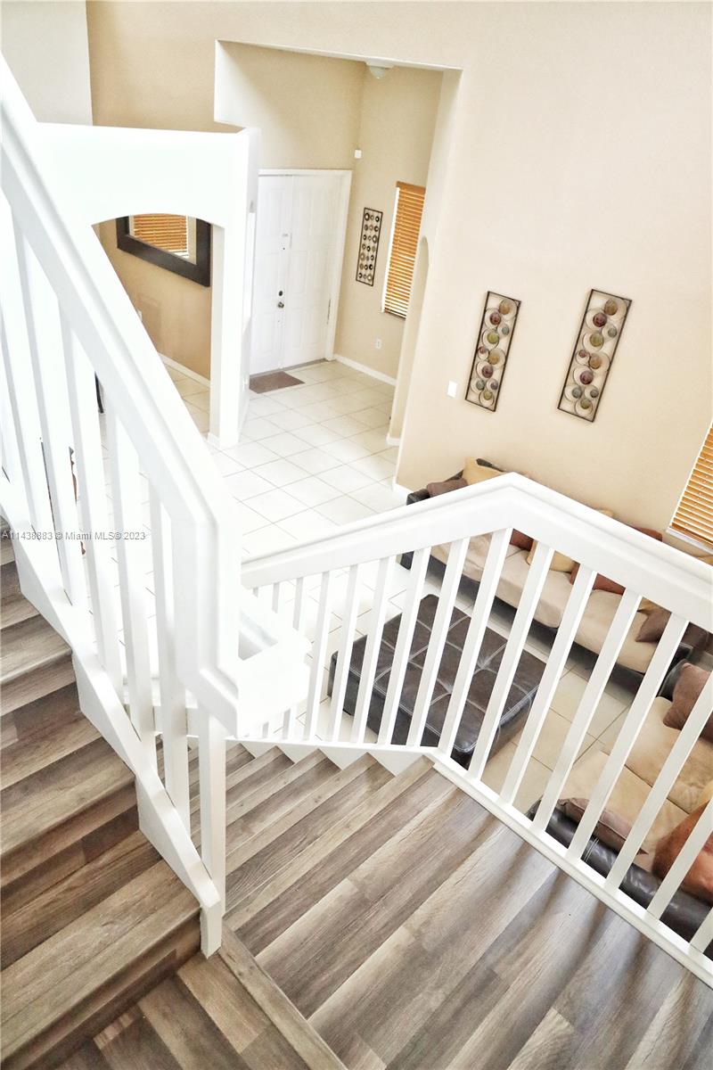 301 Southwest 87th Path Miami, FL 33174 - Photo 12 of 22 a view of a bedroom with wooden floor and white walls