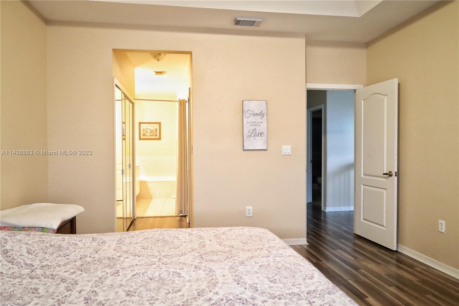 301 Southwest 87th Path Miami, FL 33174 - Photo 14 of 22 a bedroom with a bed and wooden floor