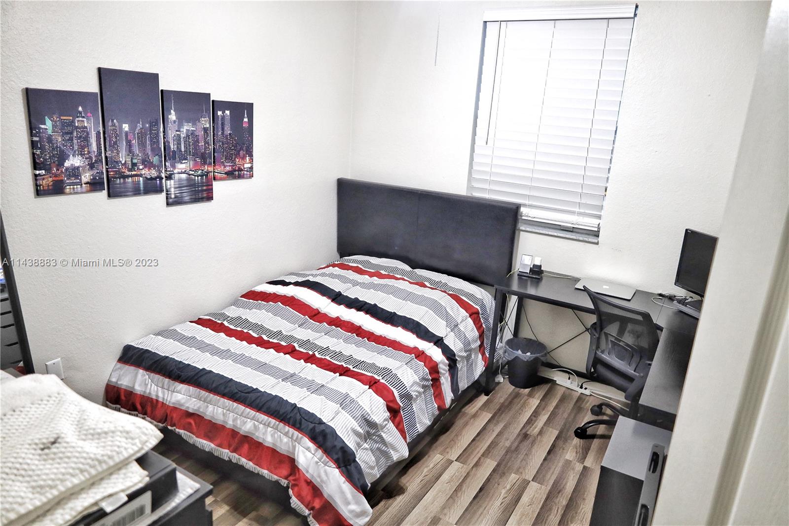 301 Southwest 87th Path Miami, FL 33174 - Photo 19 of 22 a bedroom with a bed and wooden floor