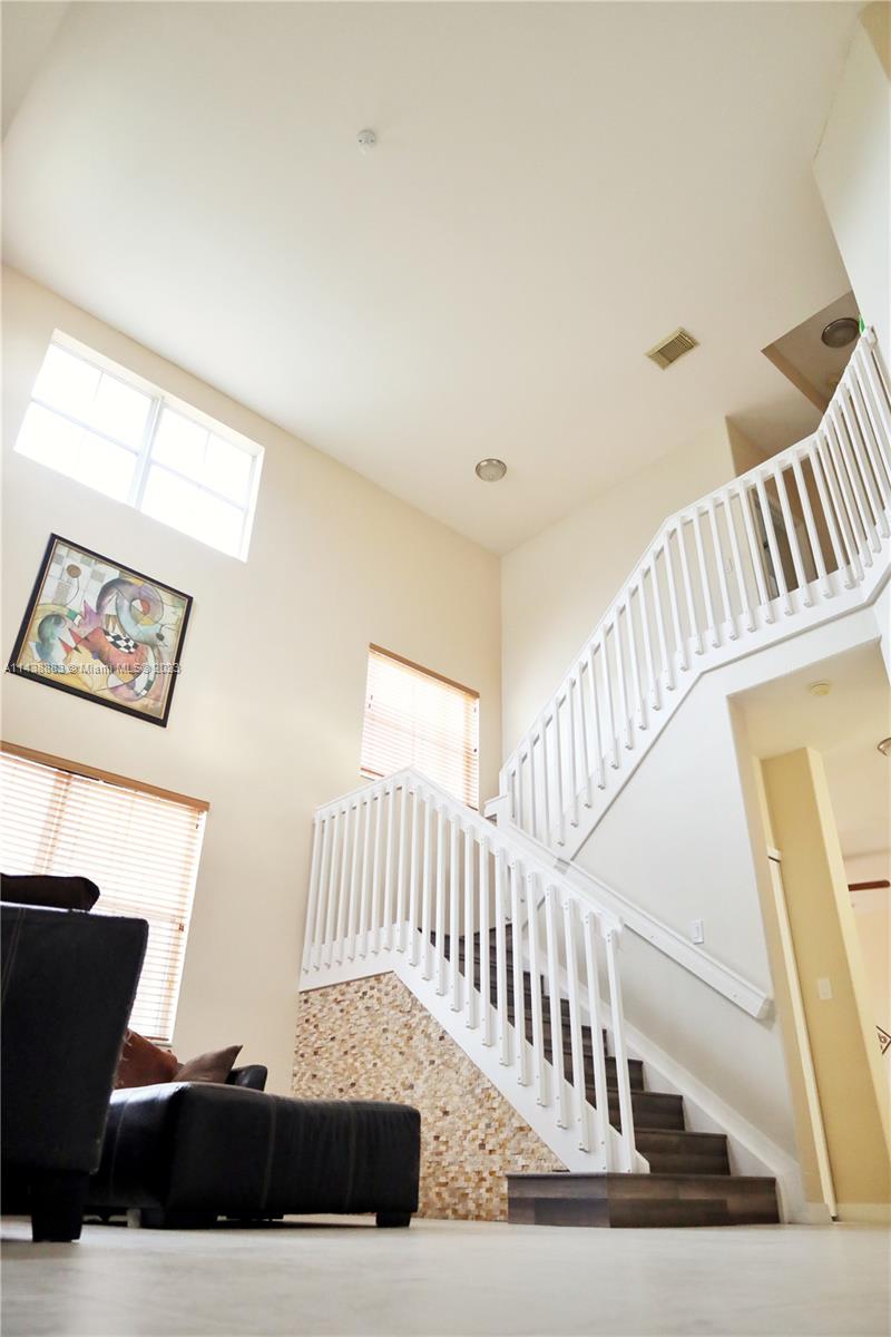 301 Southwest 87th Path Miami, FL 33174 - Photo 6 of 22 a view of staircase with lots of frames on wall and stairs