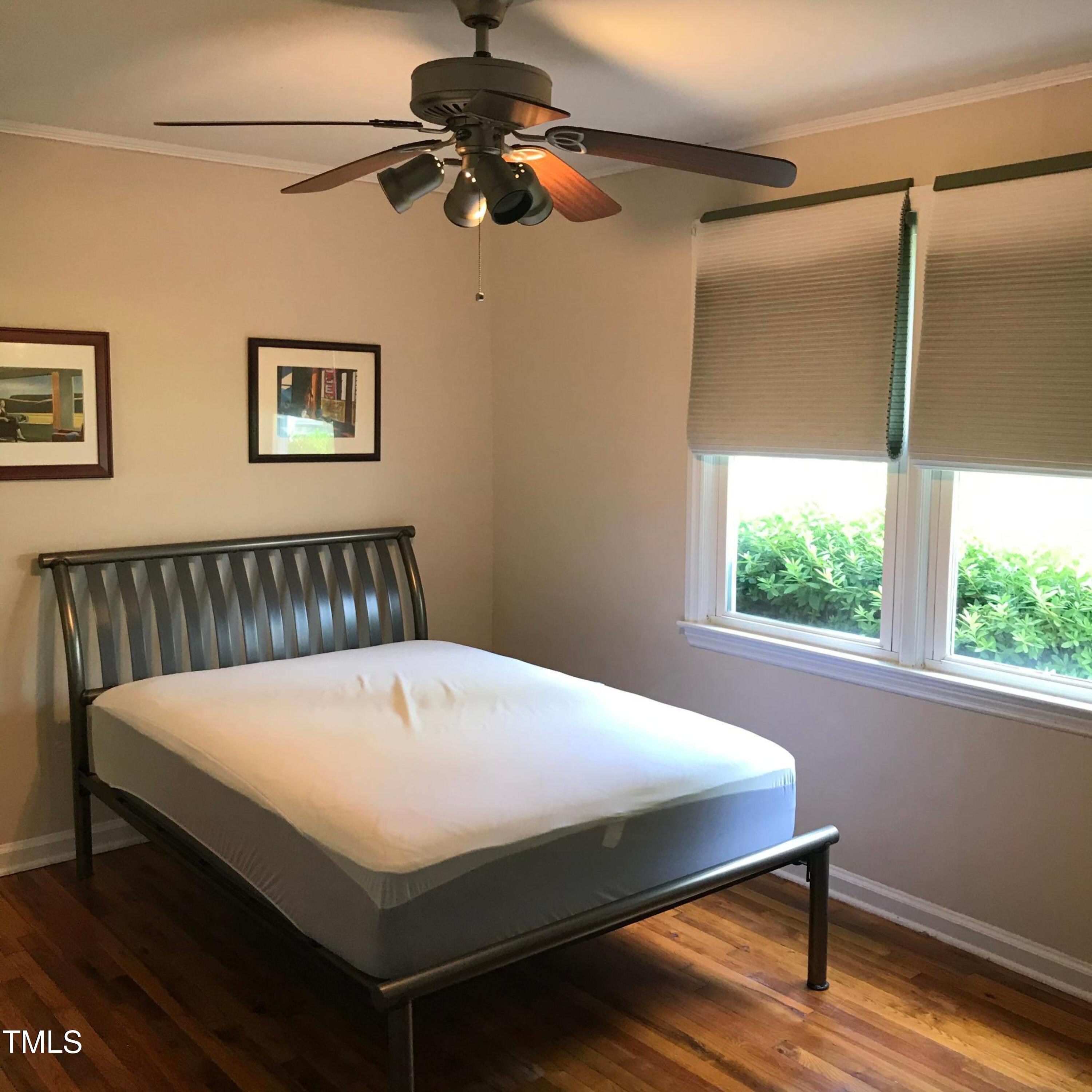 2340 Bernard Street Raleigh, NC 27608 - Photo 11 of 14 a bed sitting in a bedroom next to a window