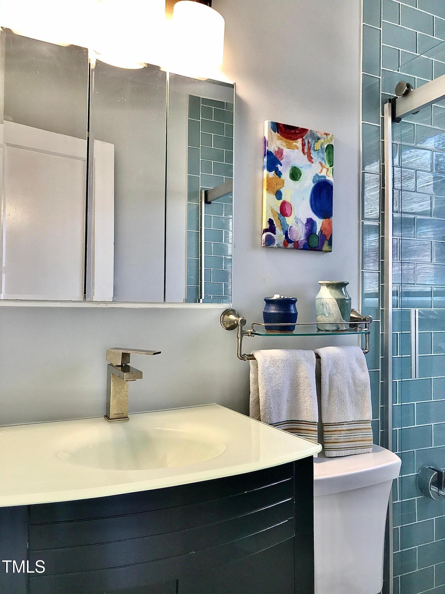 2340 Bernard Street Raleigh, NC 27608 - Photo 7 of 14 a view of bathroom with a sink a mirror and a toilet