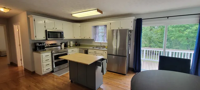 a kitchen with stainless steel appliances granite countertop a refrigerator stove microwave and sink