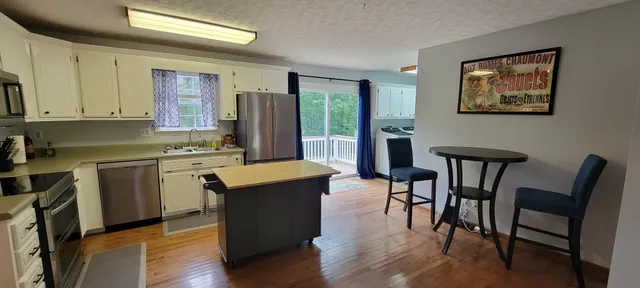 a view of a dining room with furniture and wooden floor