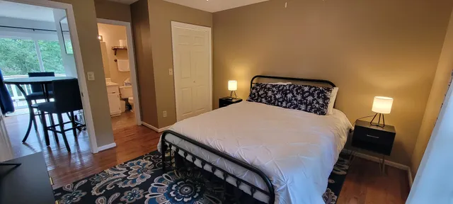 a bedroom with a bed and wooden floor