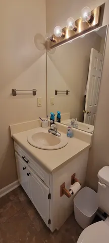 a bathroom with a sink toilet and a mirror