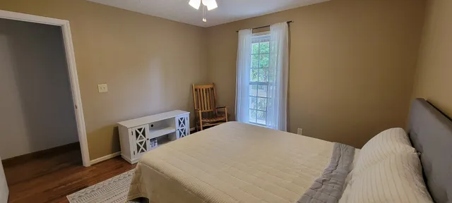 a bed sitting in a bedroom next to a window