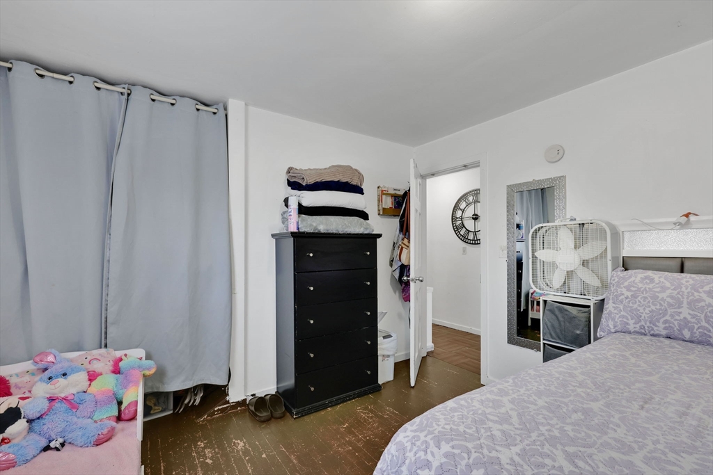 7 Kelly Place Springfield, MA 01104 - Photo 17 of 38 a bedroom with a bed and a closet