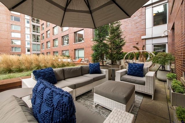 a view of a patio with couches and potted plants