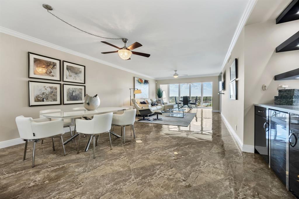 615 North Riverside Drive, Unit 702 Pompano Beach, FL 33062 - Photo 12 of 38 a living room with furniture and a large window