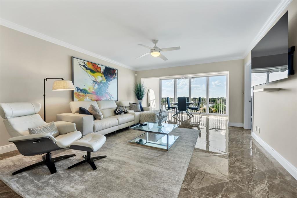 615 North Riverside Drive, Unit 702 Pompano Beach, FL 33062 - Photo 13 of 38 a living room with furniture and a flat screen tv