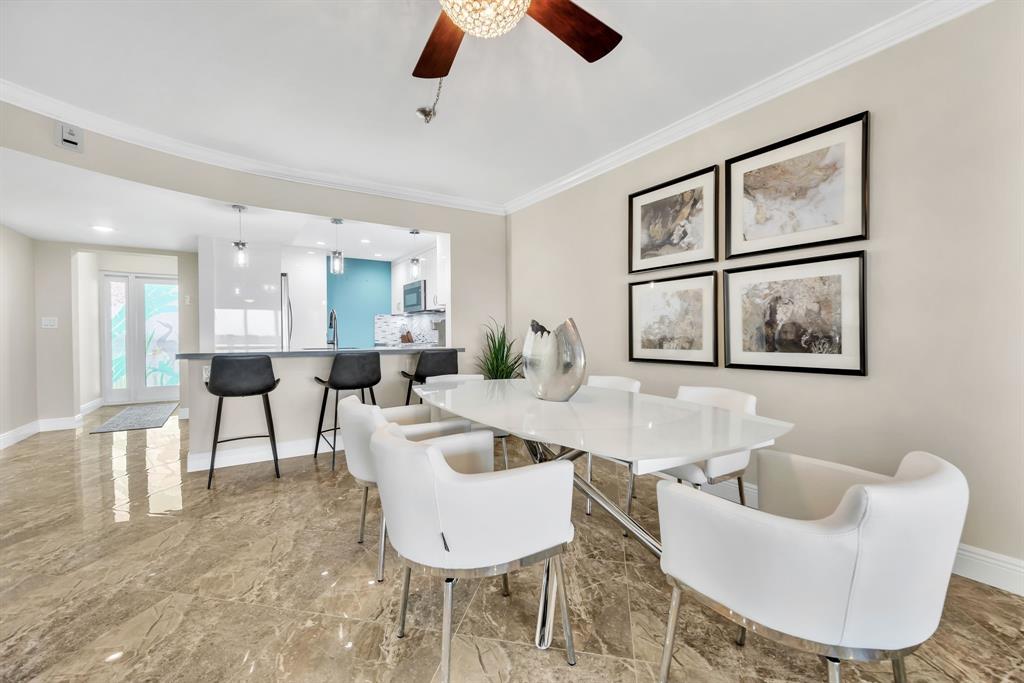 615 North Riverside Drive, Unit 702 Pompano Beach, FL 33062 - Photo 15 of 38 a living room with furniture and a large window