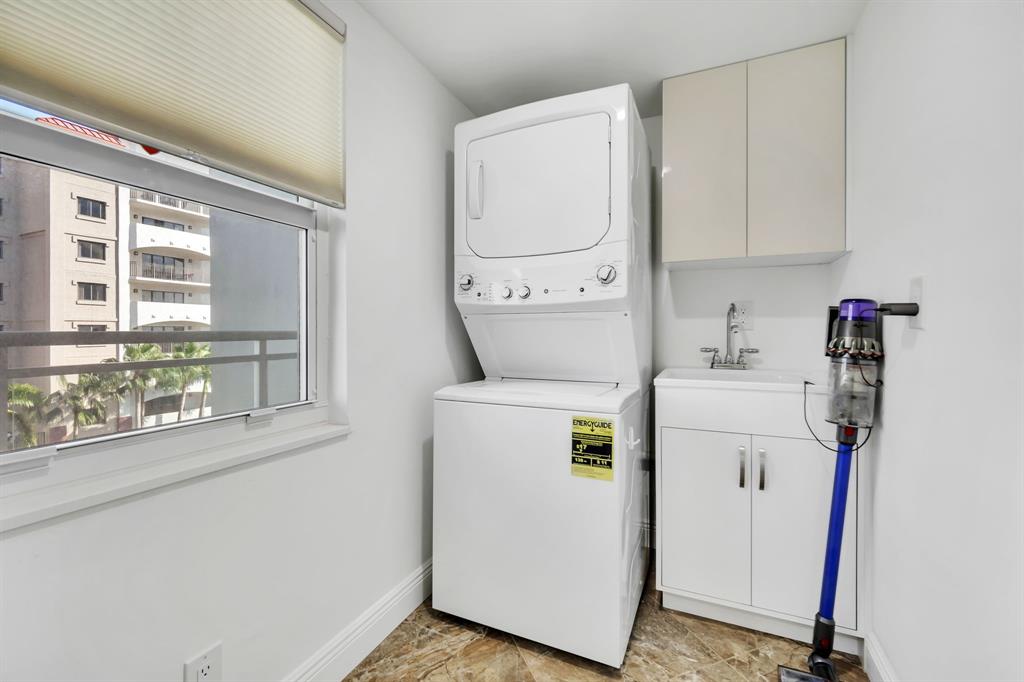 615 North Riverside Drive, Unit 702 Pompano Beach, FL 33062 - Photo 22 of 38 a utility room with dryer and washer