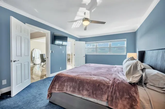 a bedroom with a bed and closet with wooden floor
