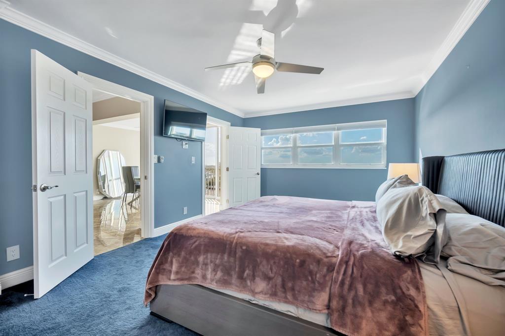 615 North Riverside Drive, Unit 702 Pompano Beach, FL 33062 - Photo 24 of 38 a bedroom with a bed and closet with wooden floor