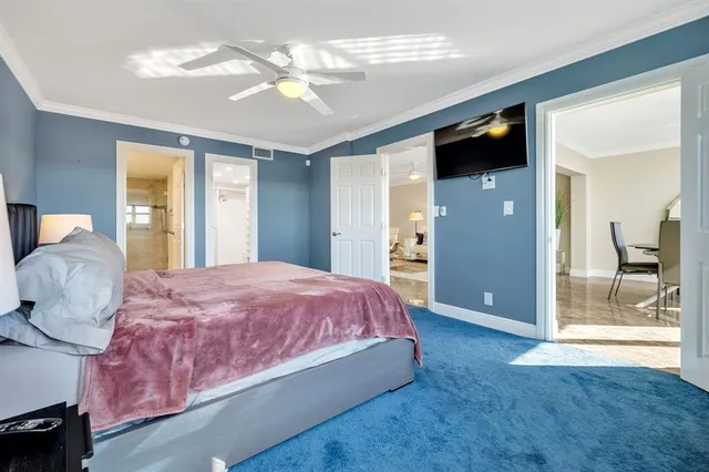 a spacious bedroom with a bed and a chandelier