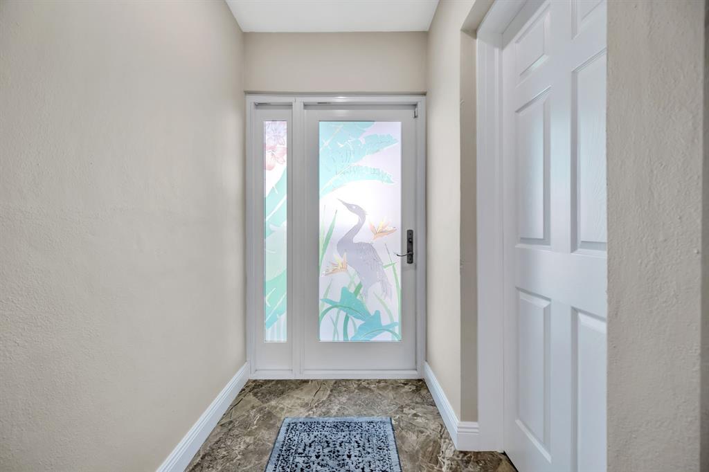 615 North Riverside Drive, Unit 702 Pompano Beach, FL 33062 - Photo 4 of 38 a view of a hallway with a window